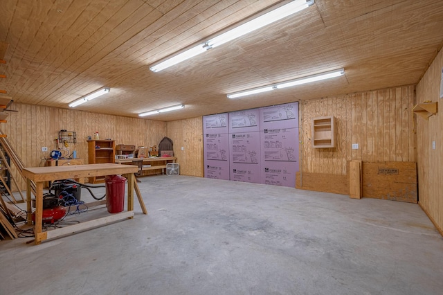 below grade area featuring a workshop area, wooden ceiling, and wooden walls