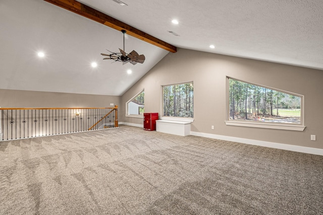 interior space featuring baseboards, vaulted ceiling with beams, a wealth of natural light, and carpet