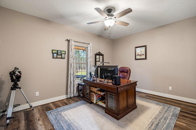 office with a textured ceiling, baseboards, and wood finished floors