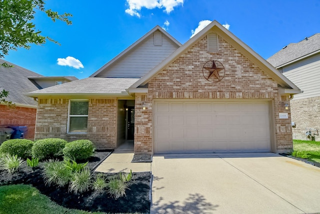 view of front of house featuring a garage, brick siding, concrete driveway, and a shingled roof