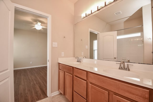 bathroom featuring double vanity, a ceiling fan, visible vents, and a sink