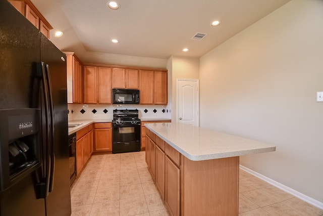 kitchen featuring visible vents, backsplash, black appliances, and light countertops