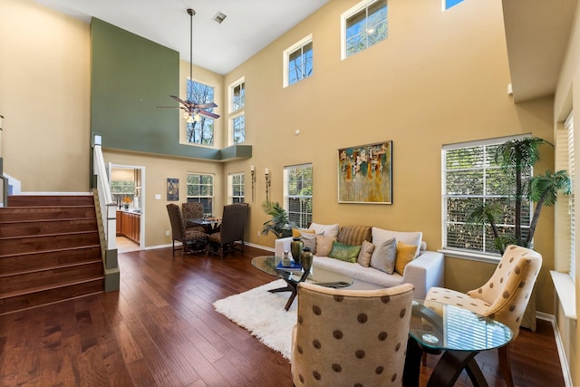 living room with baseboards, wood-type flooring, a healthy amount of sunlight, and stairs