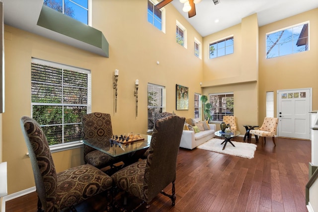 dining area featuring baseboards, plenty of natural light, and hardwood / wood-style flooring