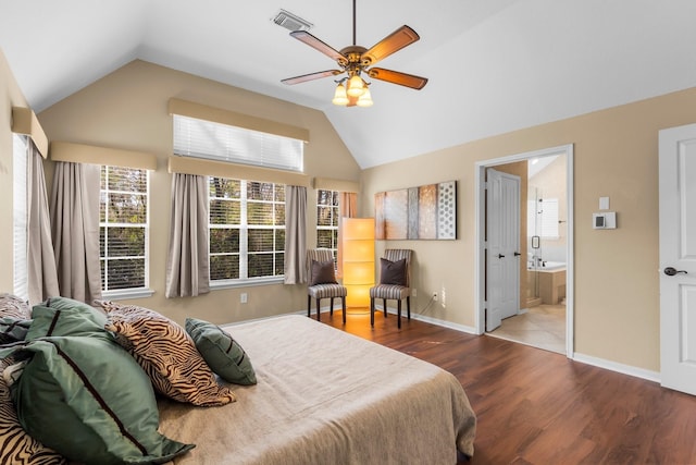 bedroom featuring visible vents, connected bathroom, baseboards, lofted ceiling, and wood finished floors