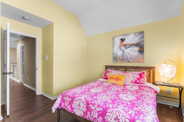 bedroom featuring vaulted ceiling, baseboards, and wood finished floors