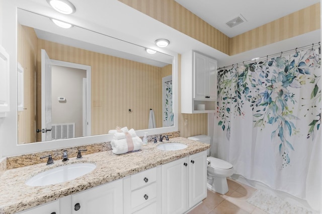 bathroom with visible vents, wallpapered walls, a sink, tile patterned floors, and toilet