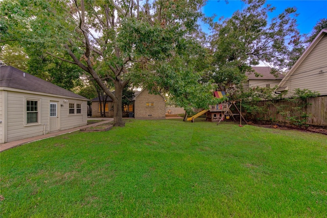 view of yard featuring a playground and fence
