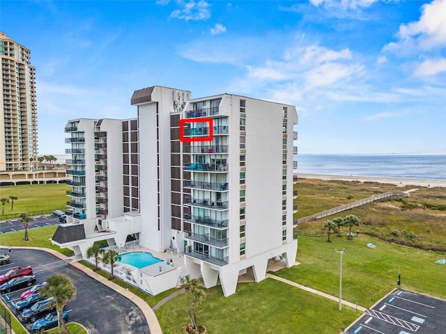 view of property featuring a beach view and a water view