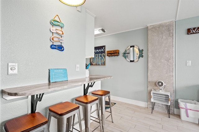 dining room with light wood-style floors and baseboards