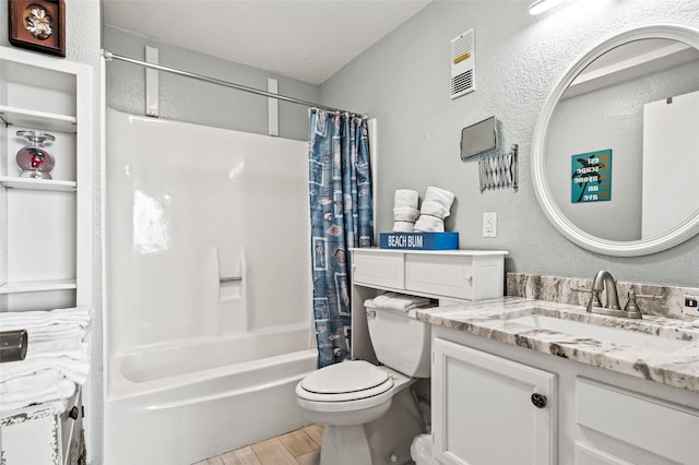 bathroom featuring vanity, wood finished floors, shower / bathtub combination with curtain, toilet, and a textured wall