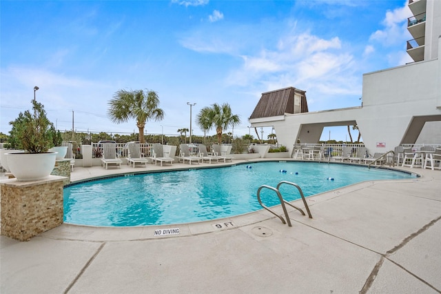 pool featuring a patio area and fence