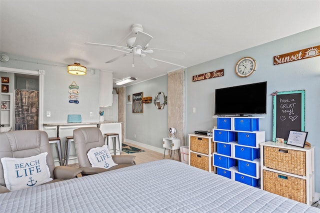 bedroom with baseboards and wood finished floors