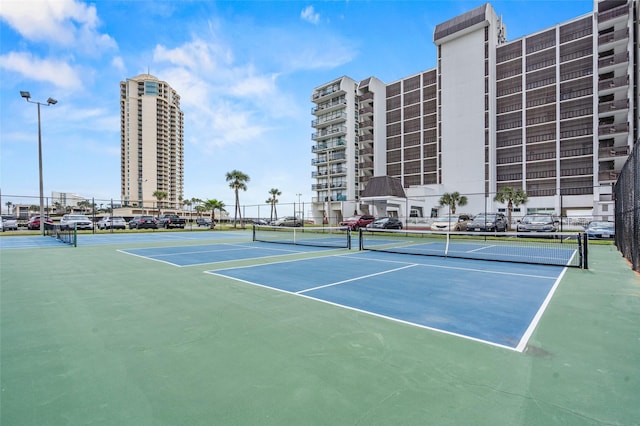 view of tennis court with fence