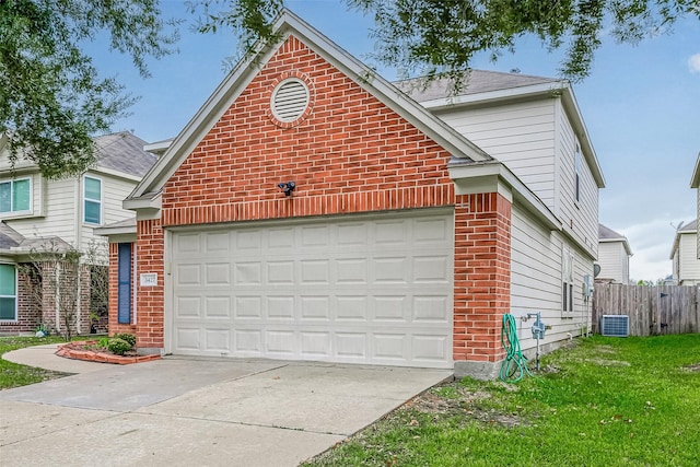 traditional-style home with brick siding, fence, central air condition unit, concrete driveway, and a garage