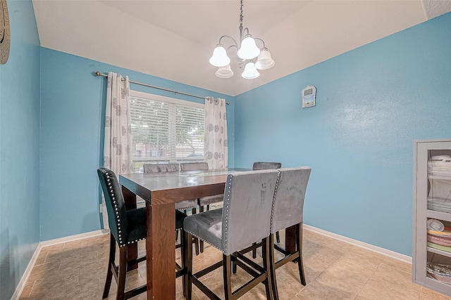 dining room featuring baseboards and an inviting chandelier