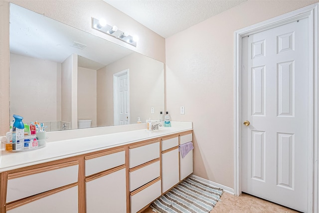 bathroom with vanity, visible vents, tile patterned flooring, a textured ceiling, and toilet