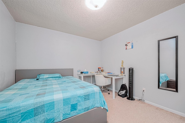 carpeted bedroom with a textured ceiling and baseboards