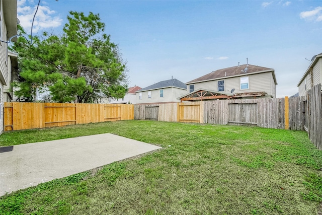 view of yard with a patio area and a fenced backyard