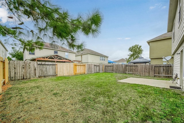 view of yard featuring a patio area and a fenced backyard