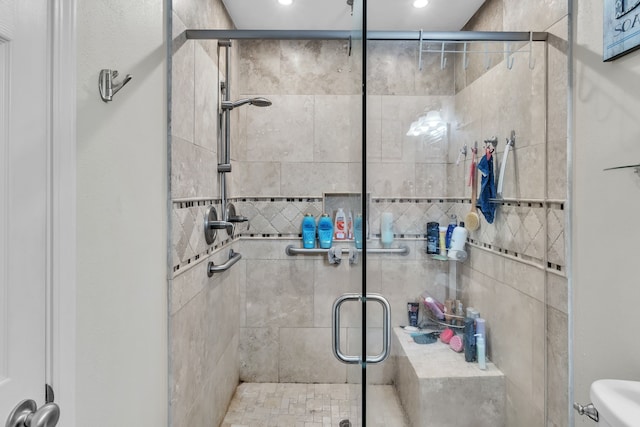 full bathroom featuring a shower stall, toilet, and recessed lighting