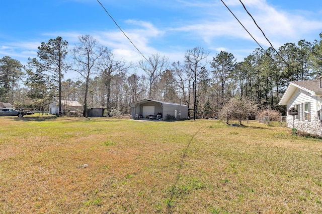 view of yard with a detached carport and driveway