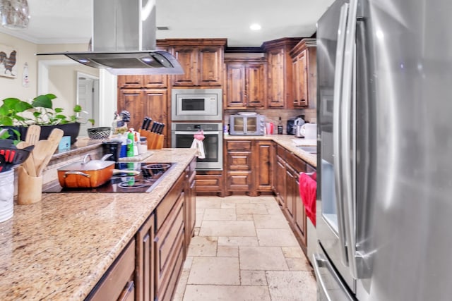 kitchen with ornamental molding, recessed lighting, island range hood, stone tile flooring, and stainless steel appliances