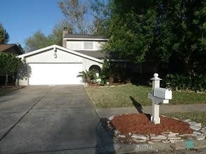 view of front of house with concrete driveway and an attached garage