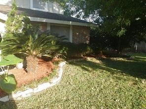 view of side of home featuring a lawn