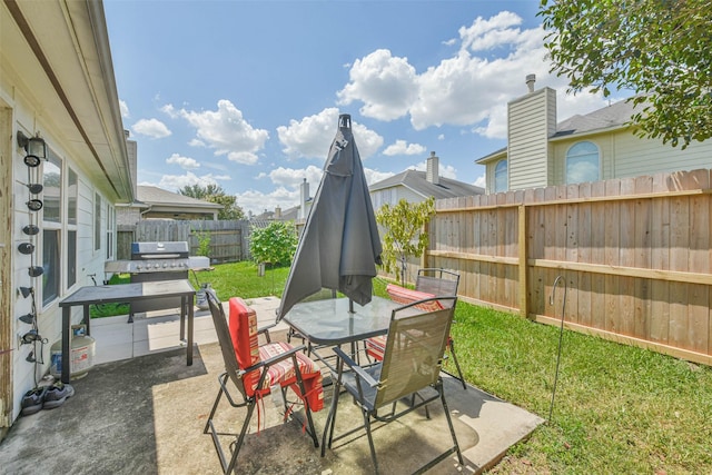 view of patio featuring outdoor dining space, a grill, and a fenced backyard