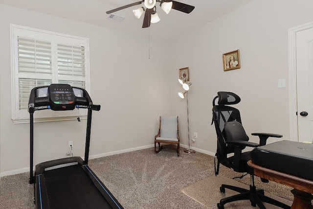 carpeted office with visible vents, a ceiling fan, and baseboards