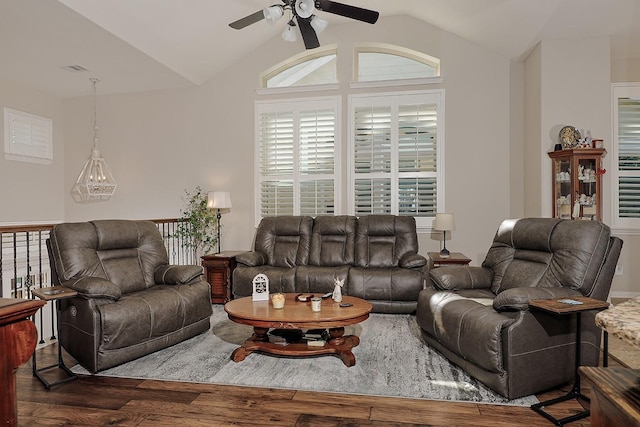 living area with a ceiling fan, vaulted ceiling, and wood finished floors