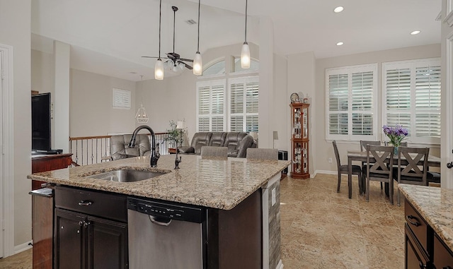 kitchen featuring pendant lighting, a sink, stainless steel dishwasher, open floor plan, and recessed lighting