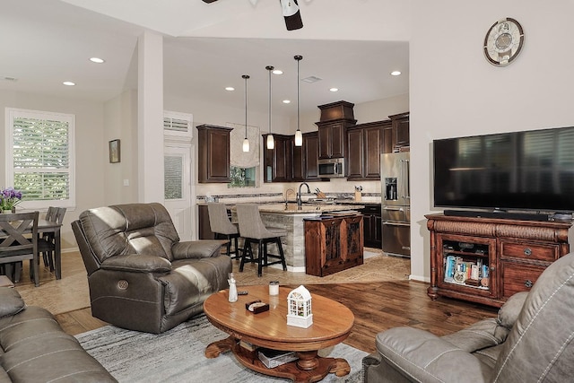 living area with light wood finished floors, visible vents, recessed lighting, and ceiling fan