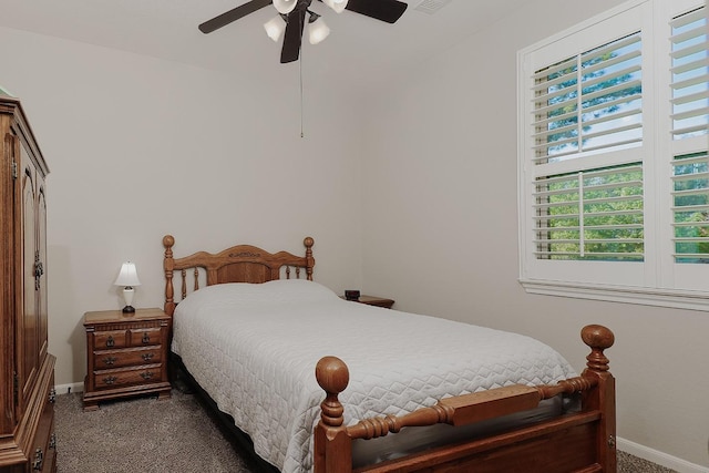 carpeted bedroom with visible vents, a ceiling fan, and baseboards