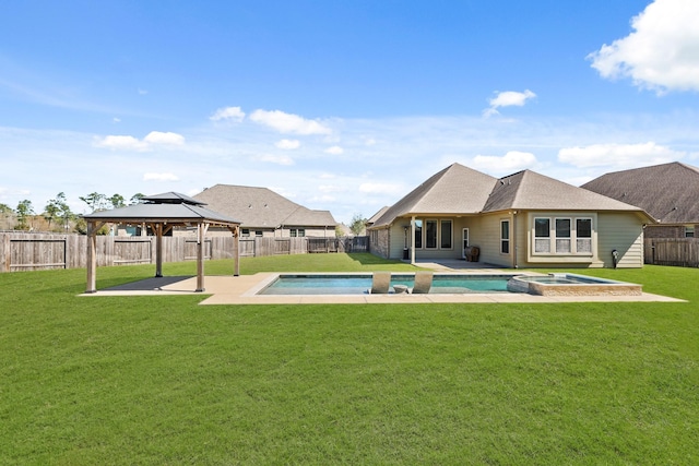 rear view of house featuring a gazebo, a yard, and a fenced backyard