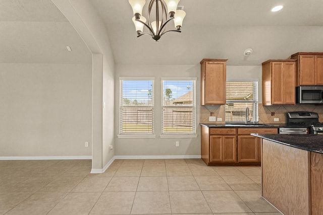 kitchen with baseboards, tasteful backsplash, appliances with stainless steel finishes, and a sink