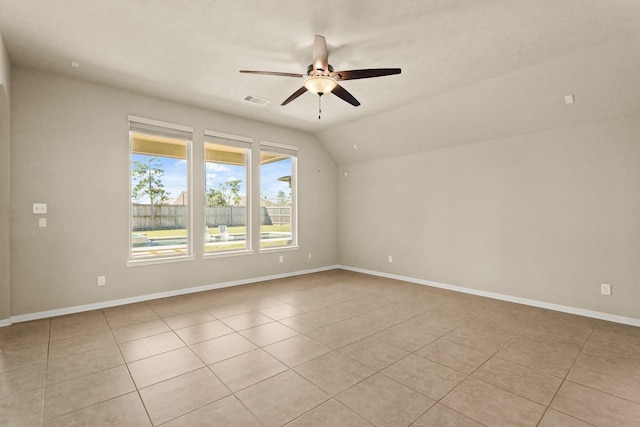 unfurnished room with visible vents, a ceiling fan, light tile patterned floors, baseboards, and vaulted ceiling