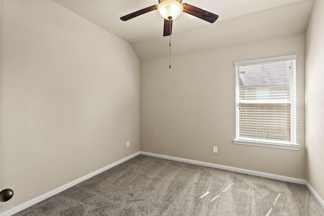 carpeted empty room with baseboards, a ceiling fan, and vaulted ceiling