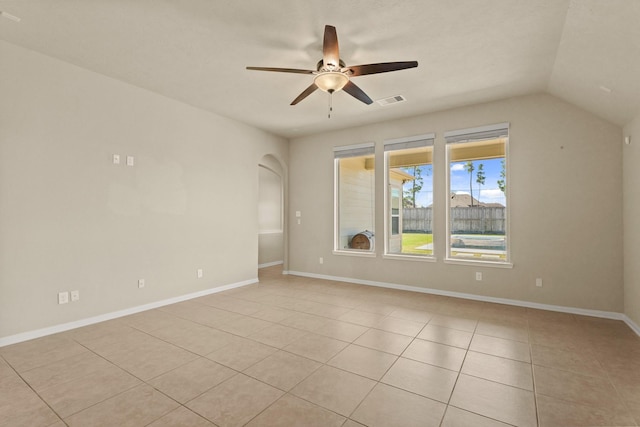 unfurnished room with visible vents, lofted ceiling, light tile patterned flooring, baseboards, and ceiling fan