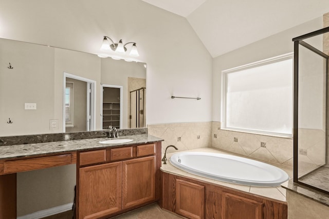 full bathroom featuring a garden tub, lofted ceiling, a stall shower, tile patterned floors, and vanity