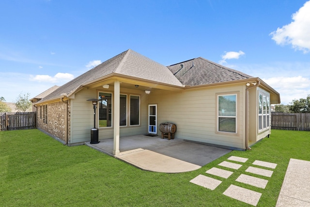 back of house with a patio area, a yard, and a fenced backyard