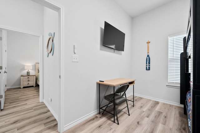 office area featuring light wood-type flooring and baseboards