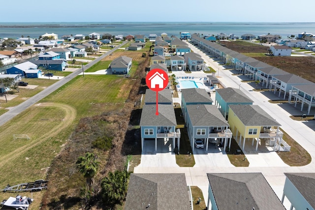 drone / aerial view featuring a water view and a residential view