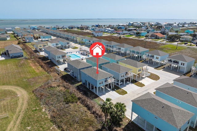 drone / aerial view featuring a residential view and a water view