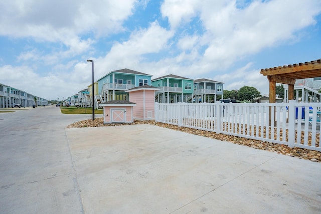 view of front facade featuring fence and a residential view
