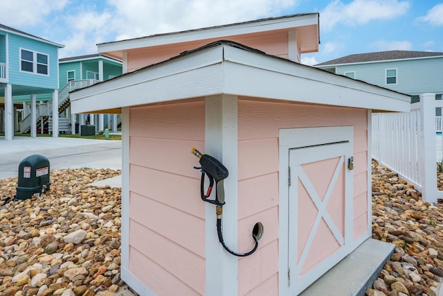 view of outdoor structure with a carport and driveway