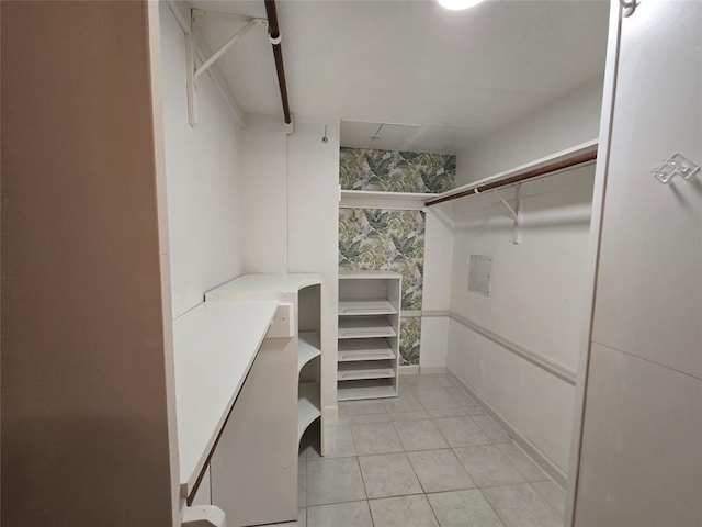 spacious closet with light tile patterned floors