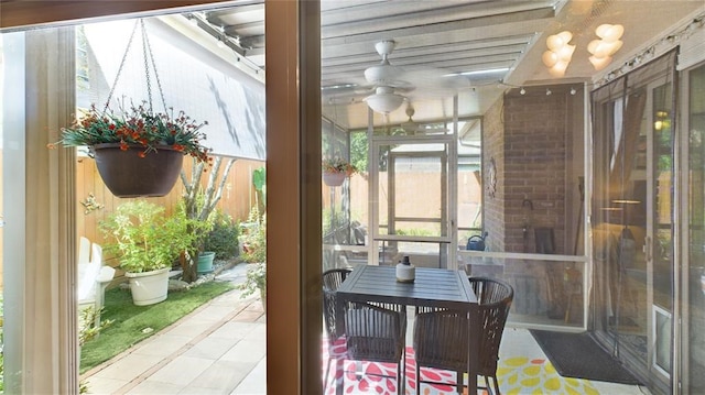 sunroom / solarium featuring ceiling fan