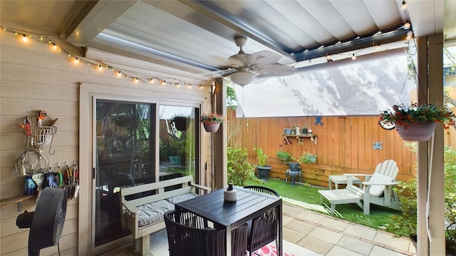 view of patio / terrace featuring ceiling fan and fence